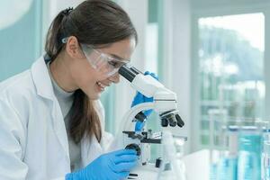 Scientist analyze biochemical samples in advanced scientific laboratory. Medical professional use microscope look microbiological developmental of viral. Biotechnology research in science lab. photo