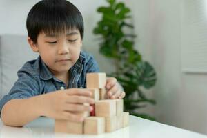 Happy Asian boy playing and learning toy blocks. children are very happy and excited at home. child have a great time playing, activities, development, attention deficit hyperactivity disorder photo