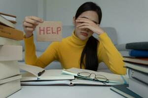 Asian student woman have anxiety because of exams, female prepare for test and learning lessons in the library. stress, despair, haste, misunderstanding reading, discouraged, expectation, knowledge photo