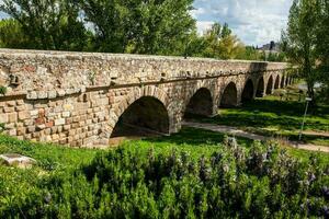The historical Roman bridge of Salamanca also known as Puente Mayor del Tormes photo