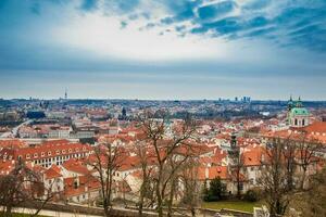 The beautiful Prague city old town seen form the Prague Castle viewpoint in an early spring day photo