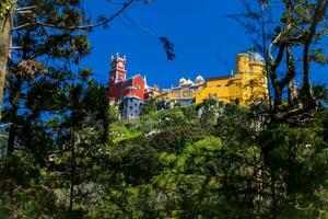 The Pena Palace seen from the Gardens of Pena Park at the municipality of Sintra photo