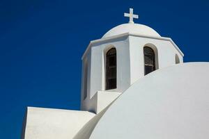 Dome of the Church of Saint Mark located next to the hiking path between Fira and Oia in Santorini Island photo