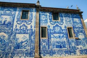 Beautiful antique wall of the Chapel of Souls of Santa Catarina decorated with traditional portuguese azulejos photo