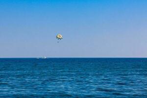 Parasailing in Perissa village beach at Santorini Island photo