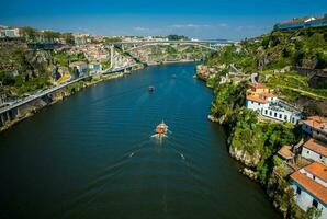 Boats sailing on the Douro River in a beautiful early spring day photo