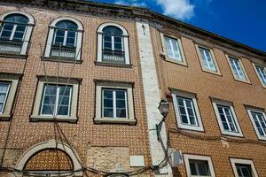 Traditional architecture of the facades covered with ceramic tiles called azulejos in the city of Lisbon in Portugal photo