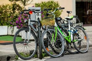 Parked bicycles at the beautiful streets of Pisa photo