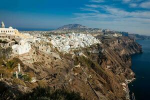 The city of Fira the Catholic Church of St. Stylianos and the Aegean sea in Santorini Island photo