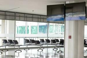 Empty wating room at an airport during COVID 19 pandemic with social distancing signs on chairs photo