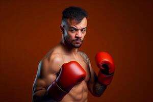 Handsome muscular man with red boxing gloves on orange background. photo