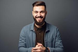 Portrait of a smiling young man in casual clothes over grey wall background photo