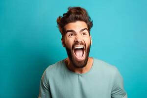 Portrait of a young man screaming isolated over blue background photo