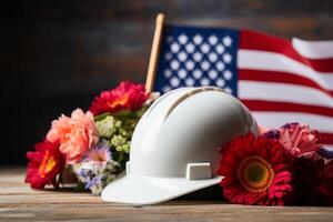 Helmet with American flag and flowers on wooden background. Labor day concept photo