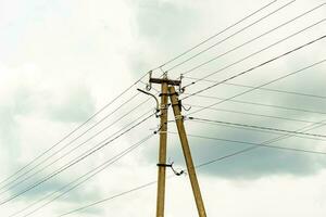 Power electric pole with line wire on colored background close up photo