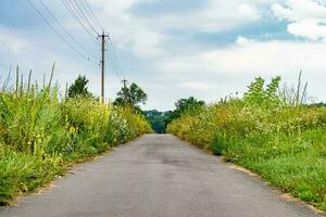 Beautiful empty asphalt road in countryside on colored background photo