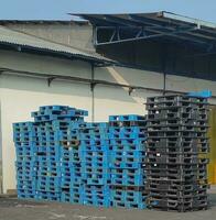 stacks of old unused plastic pallets photo