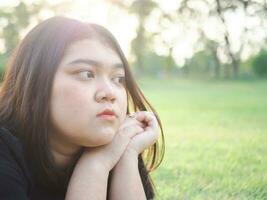 portrait young woman girl asian chubby cute beautiful long black hair one person wear black shirt looking  in garden park outdoor evening sunlight fresh smiling cheerful happy relax summer day photo