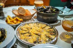 Traditional Belgian steamed mussels, mussels with cheese photo