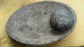 Stone rock mortar and pestle photo