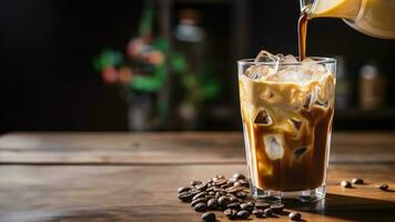 Background with a glass of cold summer coffee with ice on wooden background photo