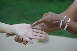 Fortune teller finger points on customer's palm. Concept , palmistry, astrology. Foretelling, mystery, magic, fortune, fate. Prediction for future life , events.  Palmist predicting. photo