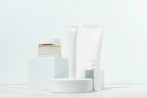 Cosmetics packaging. Set of different cosmetic jars and tubes of cream on white podiums. Blank packaging. Natural beauty spa product concept. Beauty.Mock-up photo