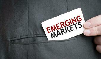 Card with EMERGING MARKETS text in pocket of businessman suit. Investment and decisions business concept. photo