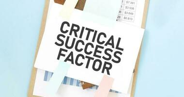 Paper plate with text take CRITICAL SUCCESS FACTOR. Diagram, notepad and blue background photo