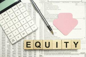 Equity - words from wooden blocks with letters, the value of a company equity concept, white background photo