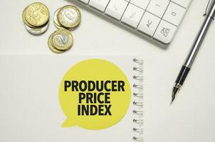 producer price index words on yellow sticker with dollars with calculator and pen photo