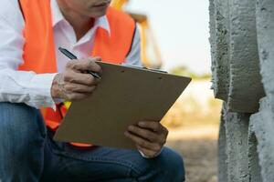 inspector or engineer is inspecting construction and quality assurance new house using a checklist. Engineers or architects or contactor work to build the house before handing it over to the homeowner photo