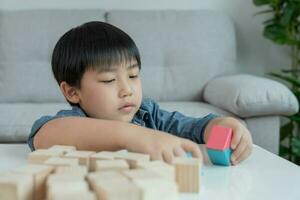 Happy Asian boy playing and learning toy blocks. children are very happy and excited at home. child have a great time playing, activities, development, attention deficit hyperactivity disorder photo