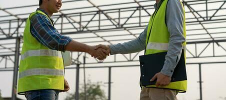 Construction worker team hands shaking greeting start up plan new project contract in office center at construction site, industry ,architecture, partner, teamwork, agreement, property, contact photo