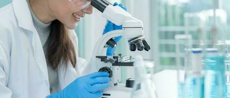 Scientist analyze biochemical samples in advanced scientific laboratory. Medical professional use microscope look microbiological developmental of viral. Biotechnology research in science lab. photo