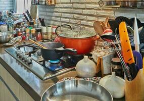 Pots with cooking food in the kitchen on gas stove photo