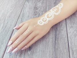 Young beautiful woman hands with elegant manicure photo