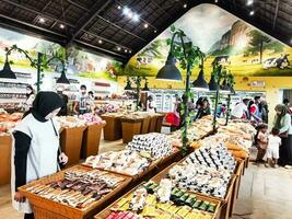 Cepogo, Boyolali, Indonesia - April 29, 2023. The atmosphere of visitors at the hawker center and souvenirs at Cepogo Cheese Park Boyolali. photo