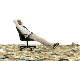 Successful businessman relaxing on a deckchair above an expanse of money photo