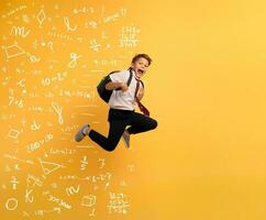 Young boy student runs fast to escape from school. Yellow background photo