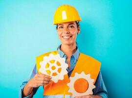 Engineer woman joins pieces of gears as concept of partnership and integration photo