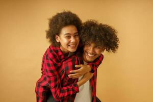 Happy and carefree afro boyfriend and girlfriend play together photo