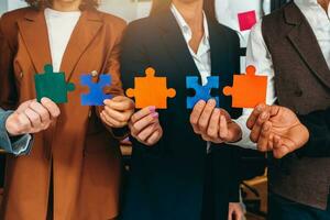 Teamwork of partners connect puzzle pieces as integration and startup photo