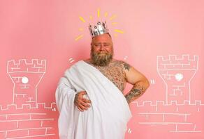 Funny man acts like an important king with a crown above the head photo