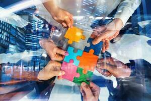 Teamwork of partners connect puzzle pieces as integration and startup photo