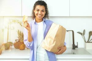 Smiling woman with a shopping bag ordered online photo