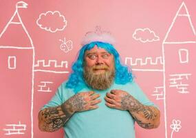 Fat amazed man with tattoos acts like a princess photo