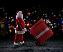 Papa Noel claus entrega un grande regalo para Navidad foto