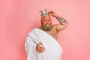 Funny man acts like an important king with a crown above the head photo