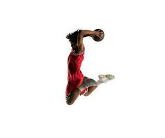 Isolated basketball player jumping to make a basket photo